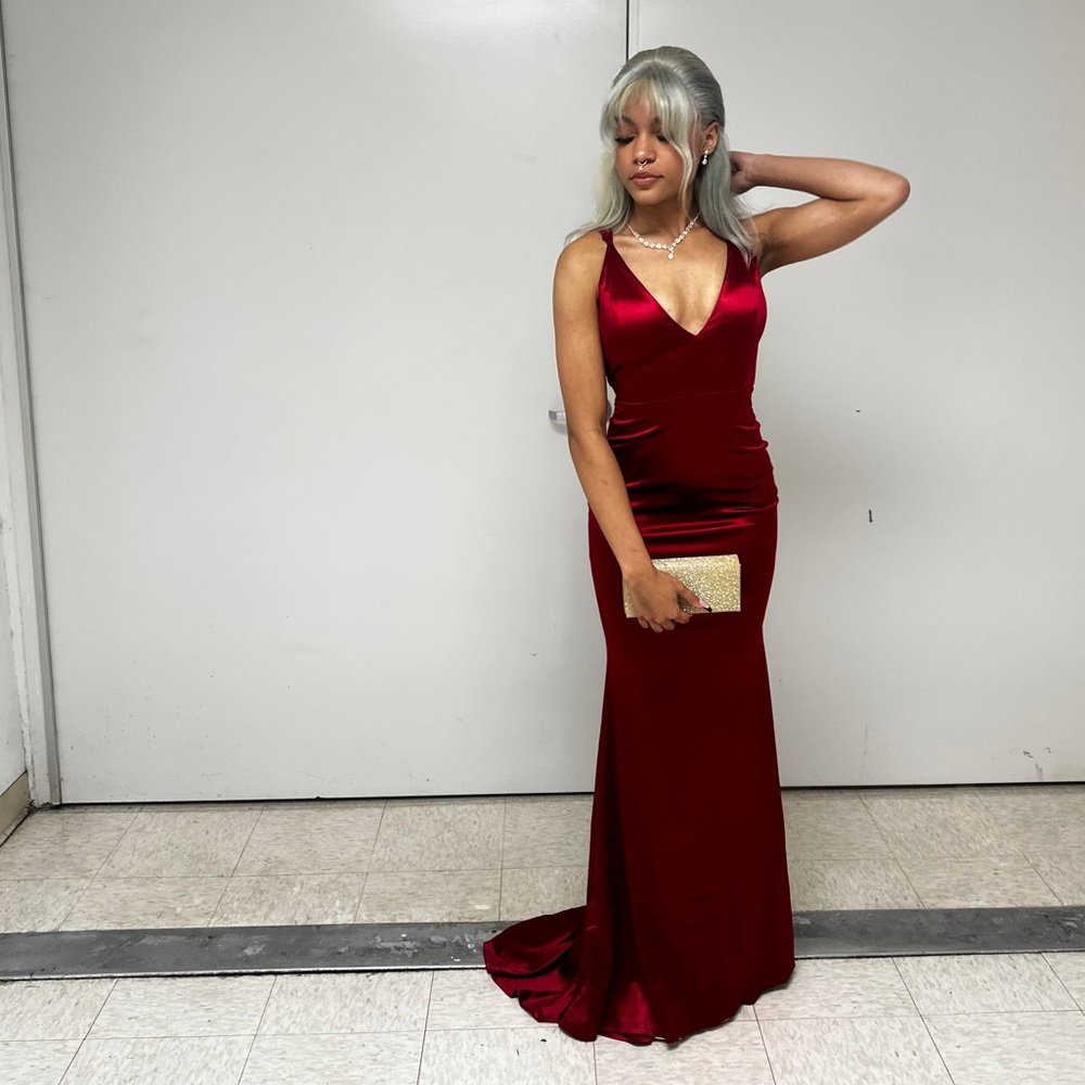 Beautiful backless red satin dress. Has a train and adjustable strings back.